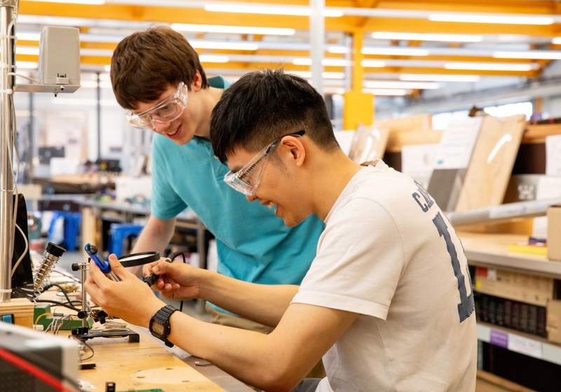 Two men working together in a workshop.