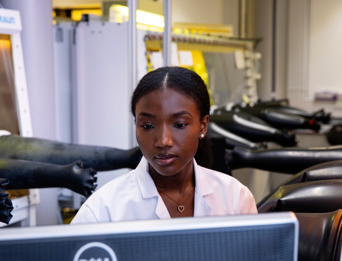 Woman in a lab looking at a computer screen.